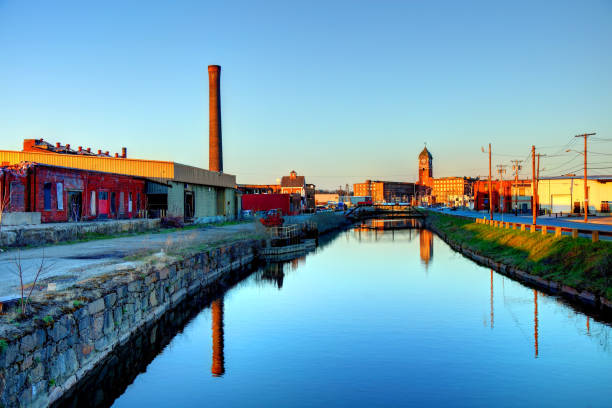 istock Mills reflecting on a canal in Lawrence, Massachusetts 679538158