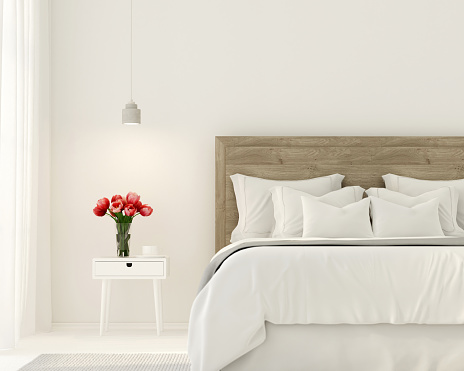 3D illustration. Interior of the bedroom in white color and with tulips on the bedside table
