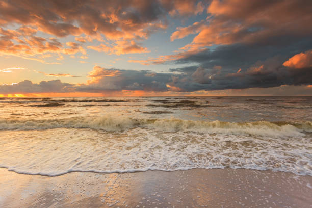 istock Beatiful sunset with clouds over sea and beach 679554328
