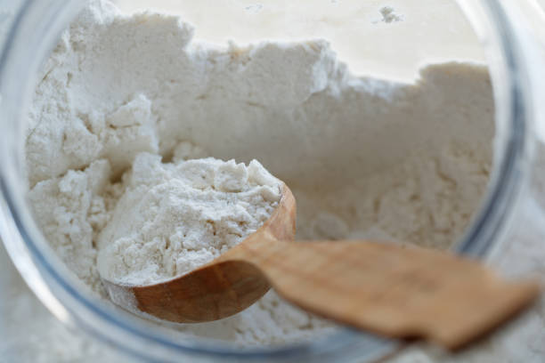 istock Close-up of a spoon with flour inside a large container 679554952