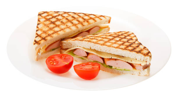 Sausage grilled cheese sandwich with tomato on a plate. Isolated on white background. stock photo