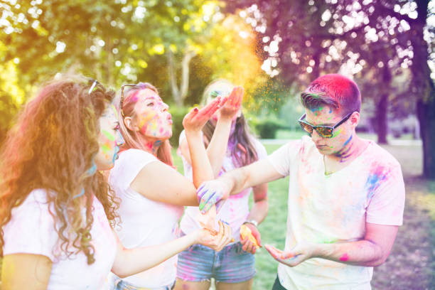 istock Four good looking friends playing with color dust in the park 679559152