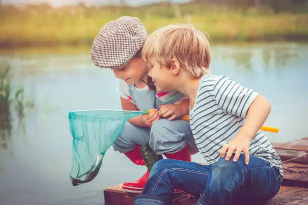 Photo of Children traveling on raft and fishing