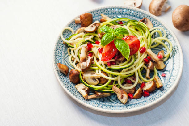 Delicious Zoodles with Mushrooms and Pomegranate Seed Delicious Zoodles with Mushrooms and Pomegranate Seed atkins diet stock pictures, royalty-free photos & images