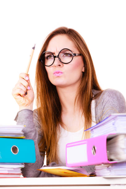 istock Woman sitting at desk in office and thinking 679575784