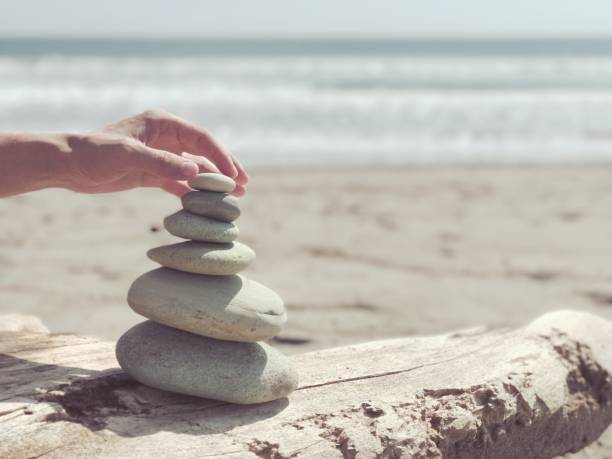 istock Stack of zen stones on the sea beach. 679583372