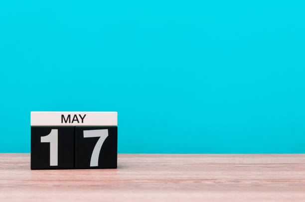 istock May 17th. Day 17 of month, calendar on turquoise background. Spring time, empty space for text 679586218