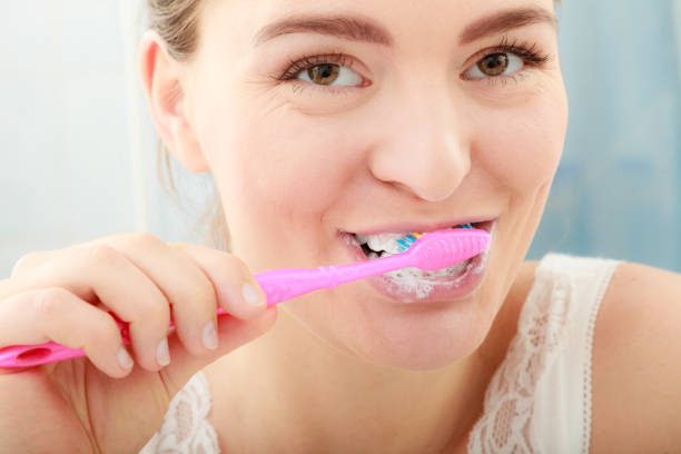 istock Woman brushing cleaning teeth. Oral hygiene. 679590644