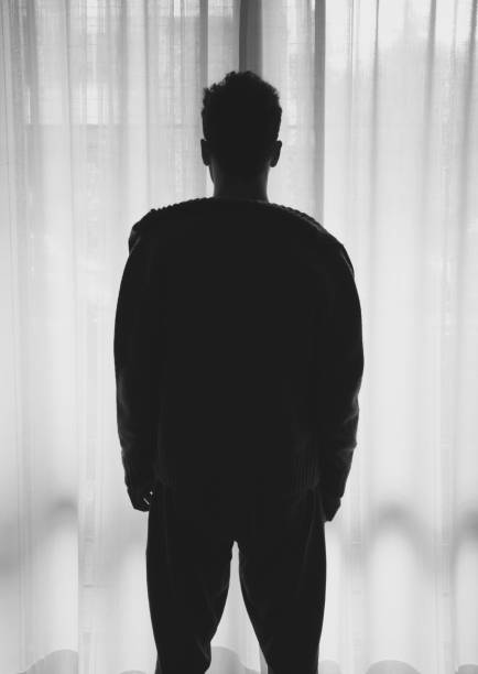 istock Young adult man looking forward through a window 679592630