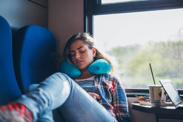 Tired from all that travel Young pretty woman napping in public transport neck pillow stock pictures, royalty-free photos & images