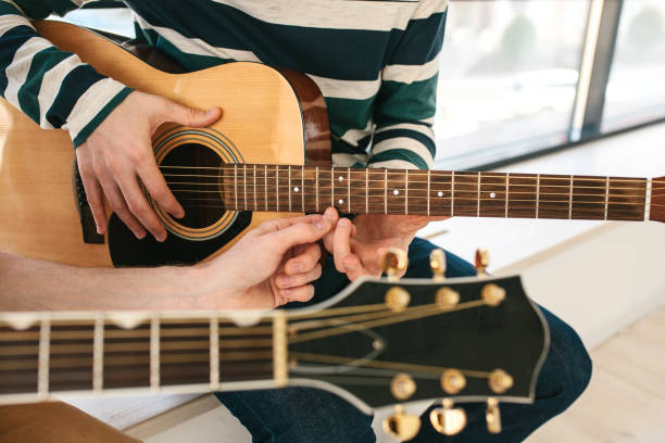 istock Learning to play the guitar. Music education and extra-curricular lessons. 679603060