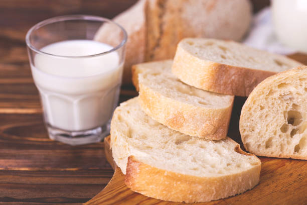 istock Sliced wheat bread, glass of fresh milk 679614032