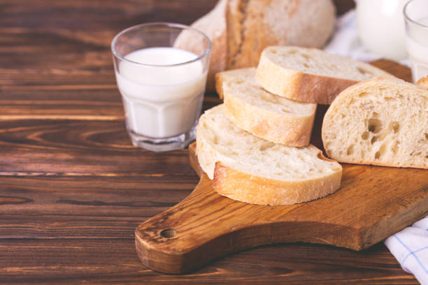 istock Sliced wheat bread, glass of fresh milk 679614142