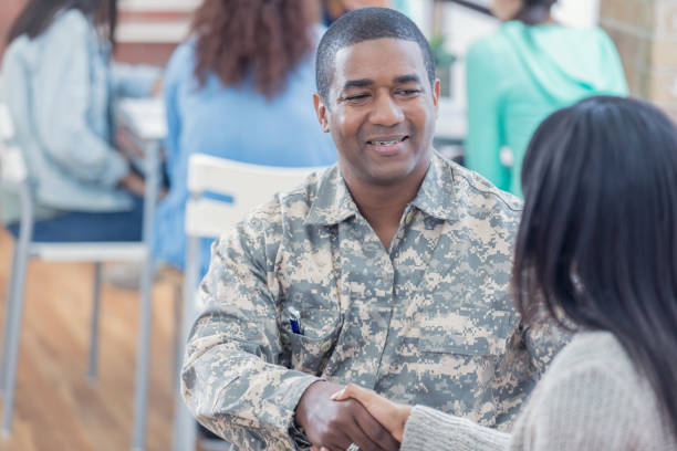 istock Military veteran greets student at recruitment event 679615234