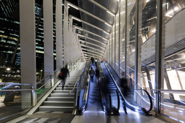 istock Futuristic moving stairway showing office workers in time blur 679617052