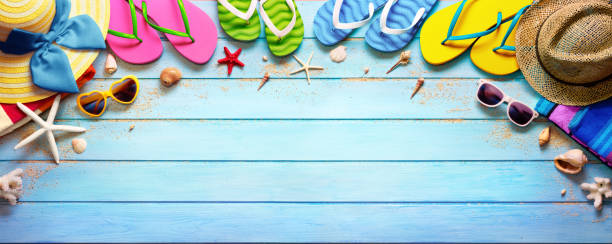 istock Four Pair Flip flops With Hats And Sunglasses On Wooden Plank 679617432