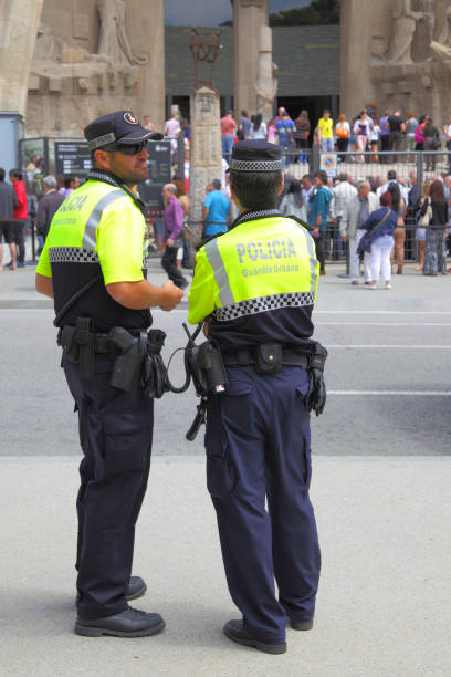 Police patrol in Barcelona Barcelona, Spain - June 09, 2011: Police patrol near main entrance of La Sagrada Familia cathedral in Barcelona police policewoman women spain stock pictures, royalty-free photos & images