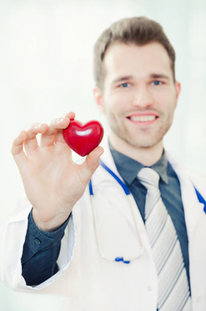 istock Doctor holds a heart shaped model in his hand 679625630