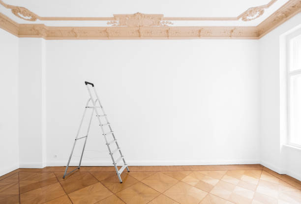 ladder in empty room with white wall and wooden floor