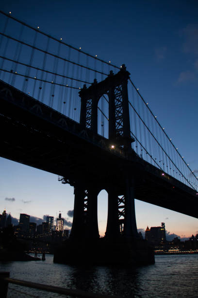 istock Manhattan bridge in silhouette at night, New York 679661696
