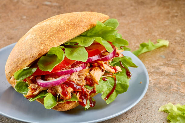 istock Sandwich with pulled pork, tomato and salad on blue dish 679661980