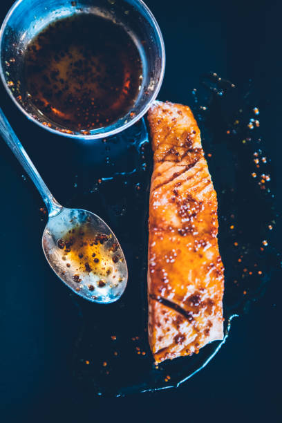 Grilled trout served on blue ceramic plate close-up showing crispy skin and delicious texture