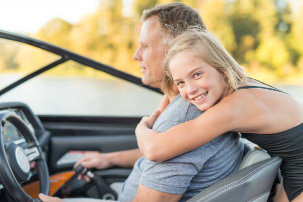istock Cute daughter hugs her father on boat 679680154