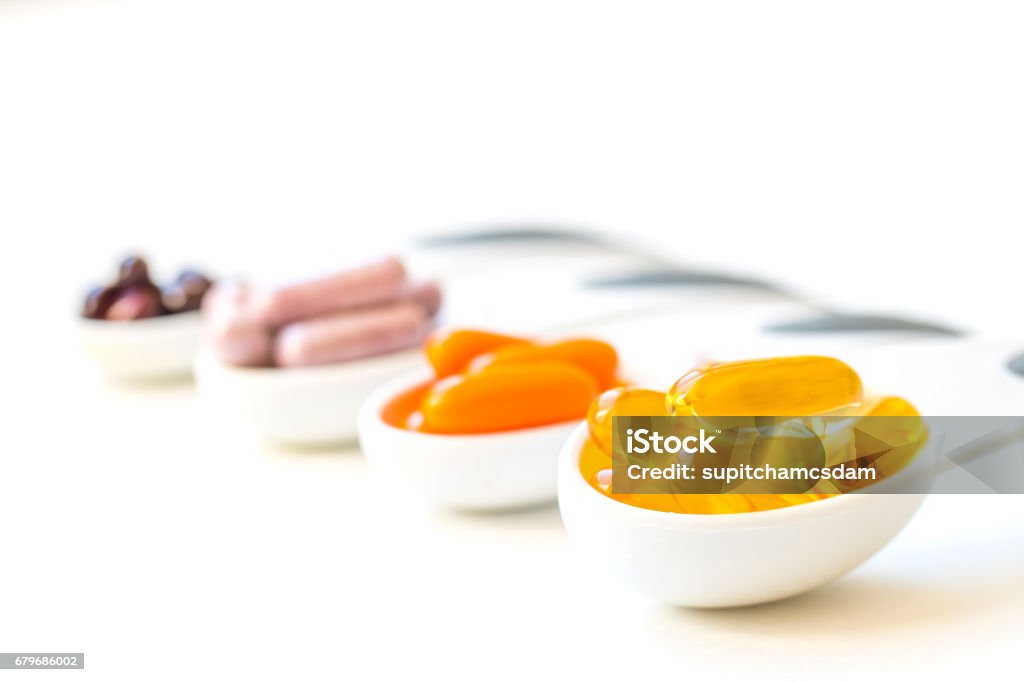 Vitamins and Healthy Supplements. Healthy Supplement capsules in a spoons CoQ10 Stock Photo