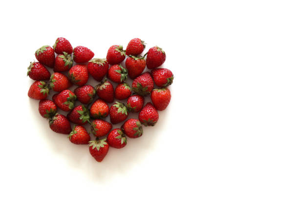 istock A heart from strawberry on the white background. 679692248