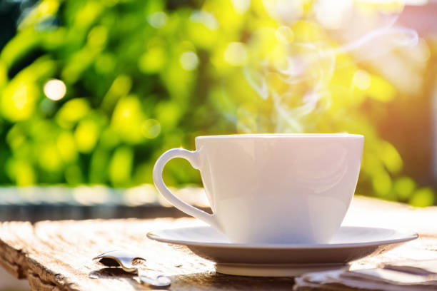 istock coffee cup clock and news paper on old wooden table 679694012