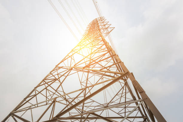 istock High voltage post against, electricity transmission pylon silhouetted sunset. 679698762