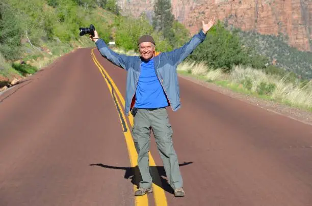 Happy Handsome Man on the Road at Zion National Park, Utah