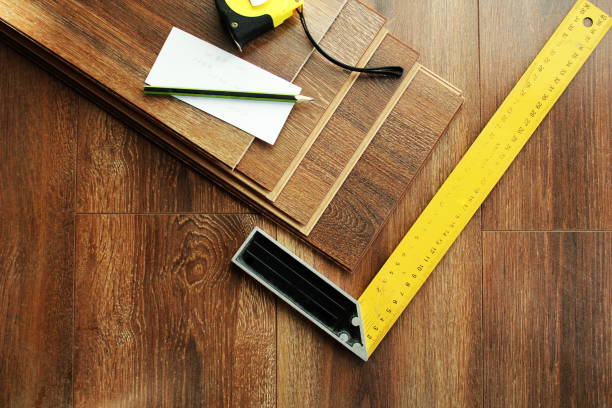 istock Laminate floor planks and tools on wooden background. Top view. 679705898