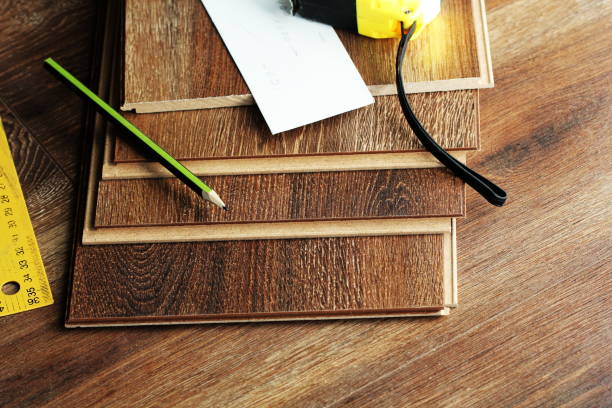 istock Laminate floor planks and tools on wooden background 679706292