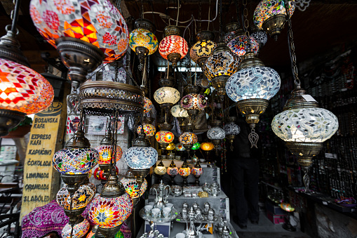 Moroccan lamp displayed in a medina store. The typical Moroccan lamps are decorated with multiple ornaments, engravings and colored crystals.