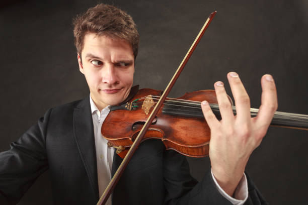 istock Man playing violin showing emotions and expressions 679718212
