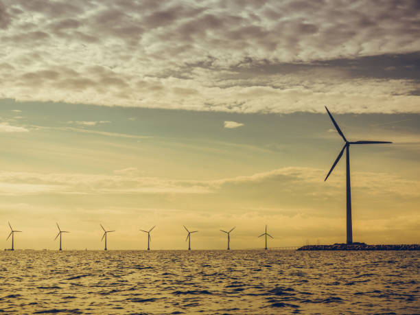 istock Wind turbines power generator farm along coast sea 679719464