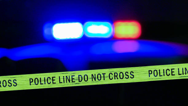 istock Defocused police car siren with boundary tape 679724730