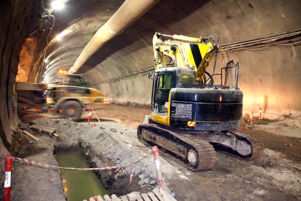 istock Concrete Road Tunnel Construction Excavator and Dump Truck 679727520