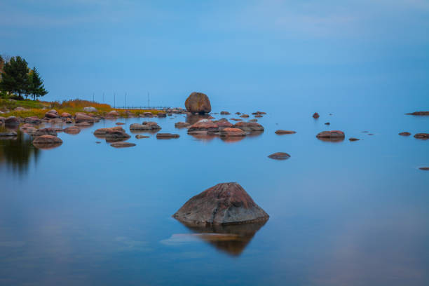 istock Baltic seaside after sunset with stones in water, long exposure 679728210