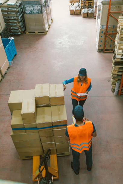 istock Male manual worker in warehouse checking merchandise 679734216