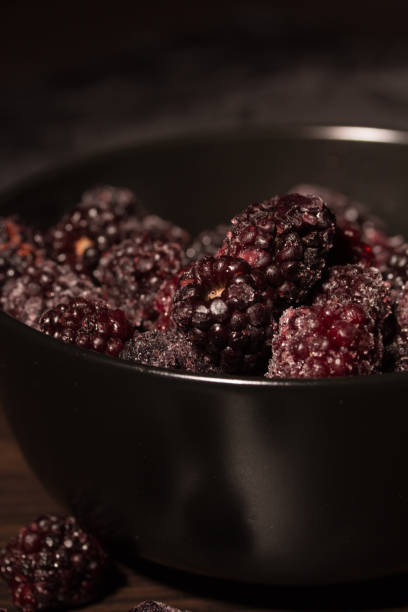 Frozen blackberries on a black plate Tasty frozen blackberries on a black plate 2590 stock pictures, royalty-free photos & images