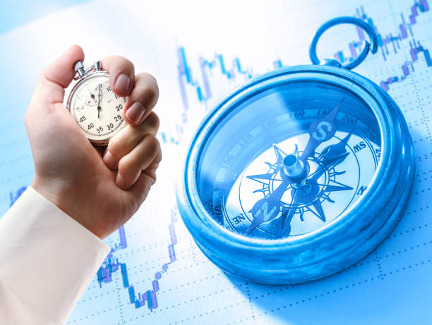 istock Candlestick chart, compass and stopwatch in male hand 679737426
