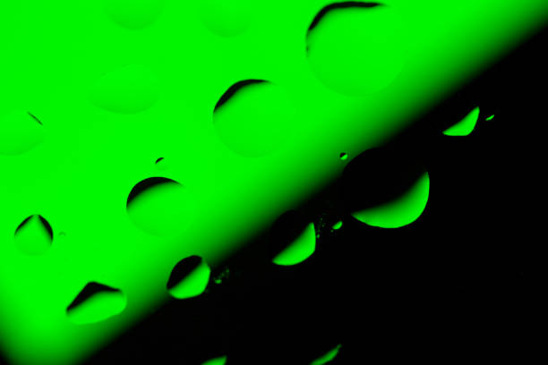 istock Abstract Background with Oil Drops on Black - Green 679738234