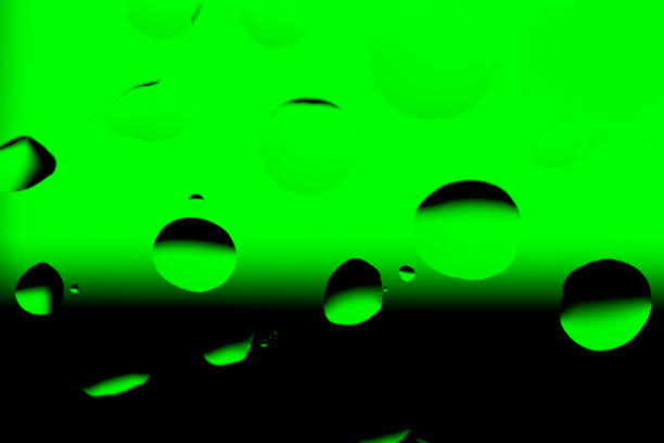 istock Abstract Background with Oil Drops on Black - Green 679738236