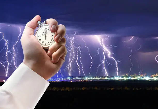 Photo of Night thunder lightning and stopwatch in male hand