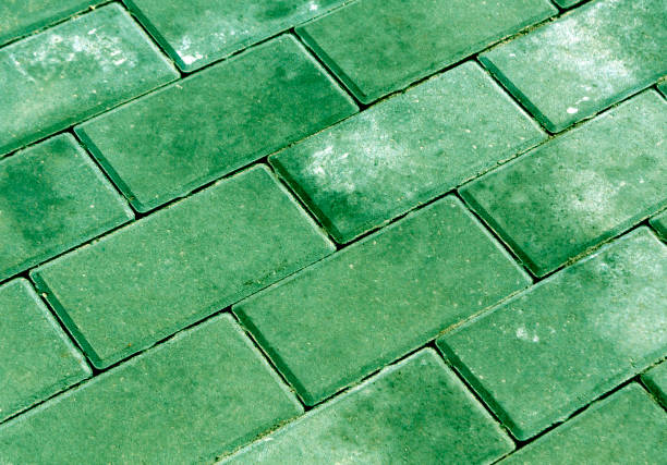 istock Green color cobblestone pavement texture 679739674