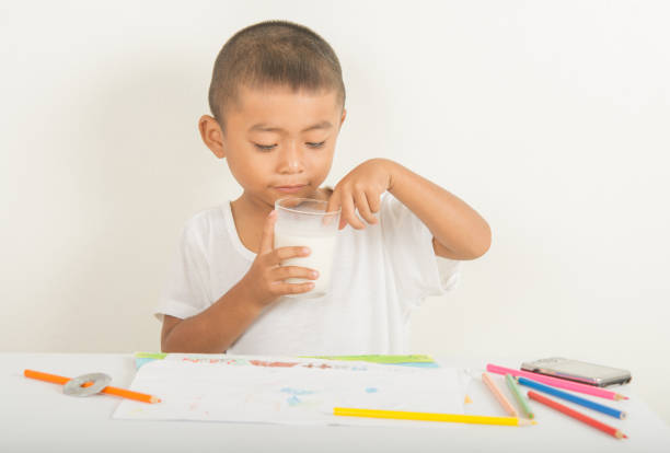 istock Boy with milk on the wrist to table 679747608