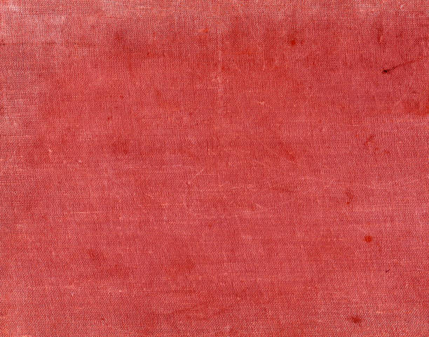 istock Red color textile surfacr with spots and scratches 679750962