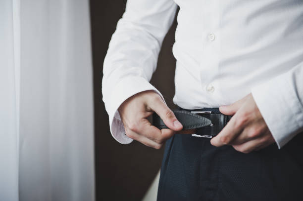istock Man buckles his belt 5760. 679754012